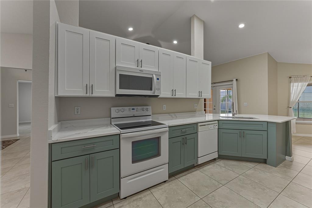 315 Cloverdale Road Winter Haven, FL 33884 - Photo 30 of 65 a kitchen with sink cabinets and stainless steel appliances