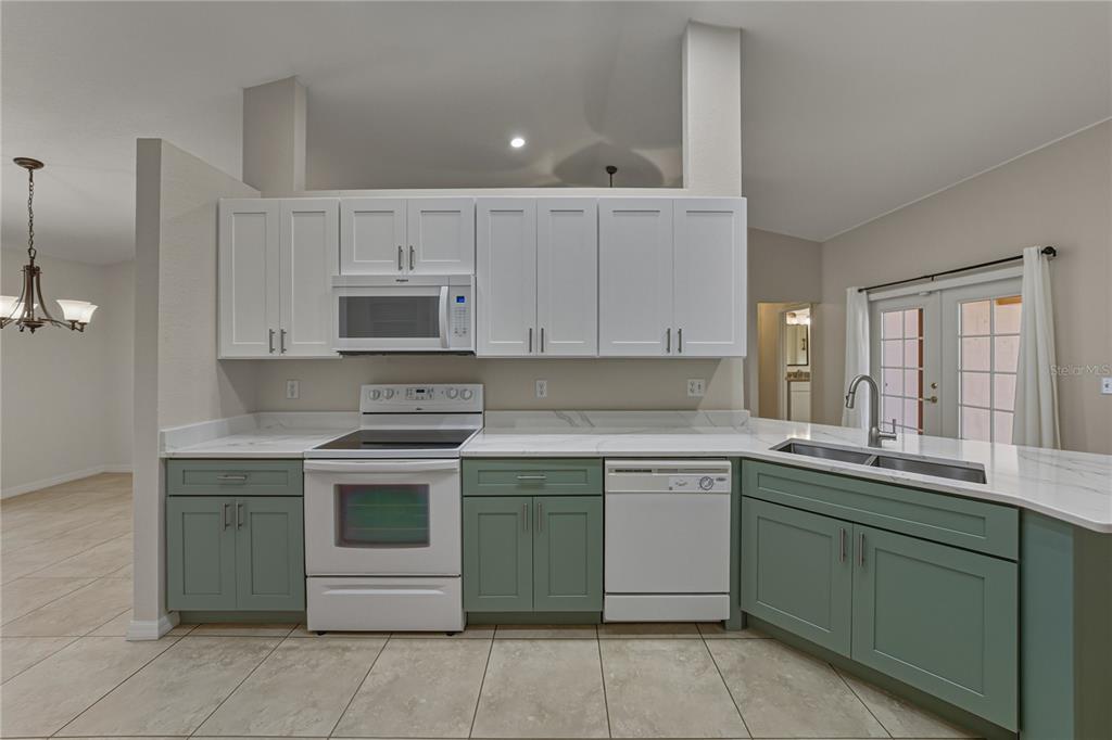 315 Cloverdale Road Winter Haven, FL 33884 - Photo 31 of 65 a kitchen with a sink stove and microwave