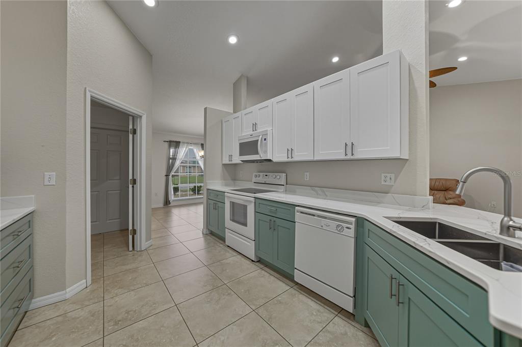 315 Cloverdale Road Winter Haven, FL 33884 - Photo 32 of 65 a kitchen with a sink cabinets and appliances