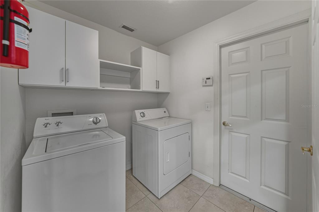 315 Cloverdale Road Winter Haven, FL 33884 - Photo 33 of 65 a view of storage and utility room with washer and dryer