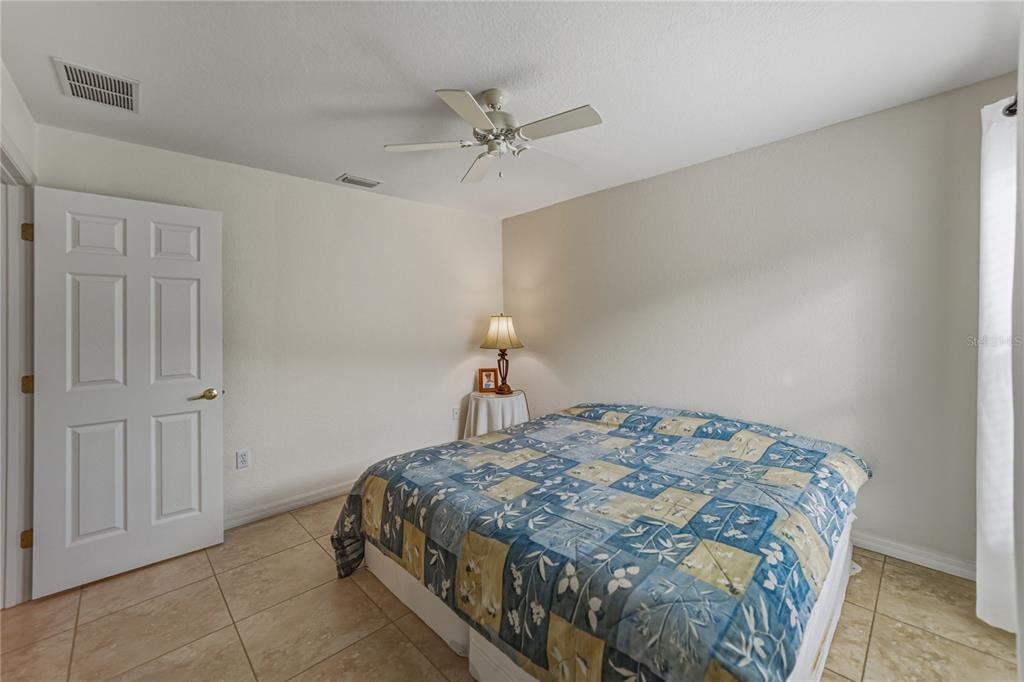 315 Cloverdale Road Winter Haven, FL 33884 - Photo 44 of 65 a bedroom with a bed and a chandelier