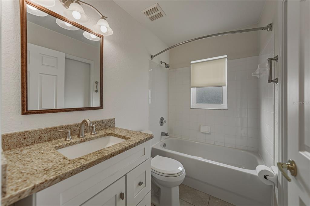 315 Cloverdale Road Winter Haven, FL 33884 - Photo 48 of 65 a bathroom with a granite countertop sink toilet and shower