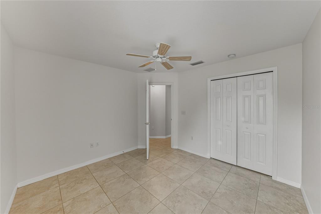 315 Cloverdale Road Winter Haven, FL 33884 - Photo 52 of 65 an empty room with a ceiling fan and a window