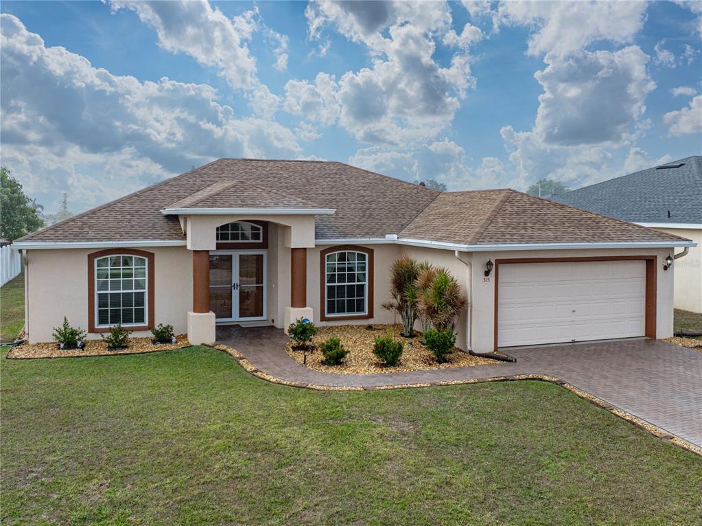 315 Cloverdale Road Winter Haven, FL 33884 - Photo 6 of 65 a front view of a house with a yard and outdoor seating