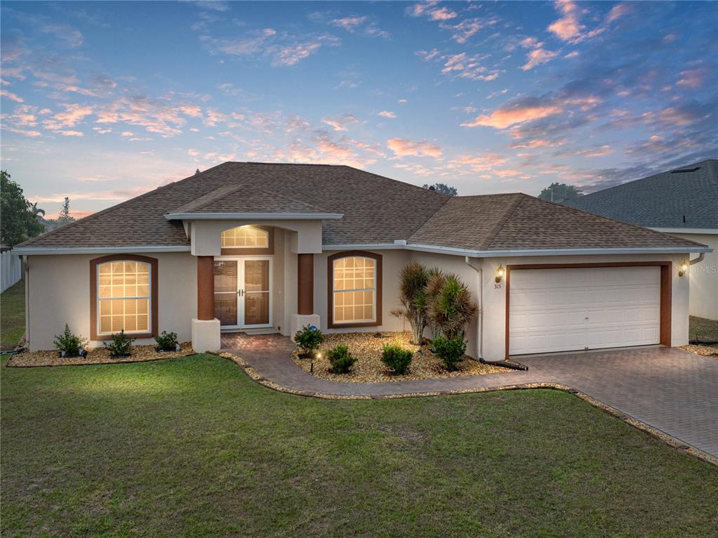 315 Cloverdale Road Winter Haven, FL 33884 - Photo 65 of 65 a front view of a house with a yard and potted plants