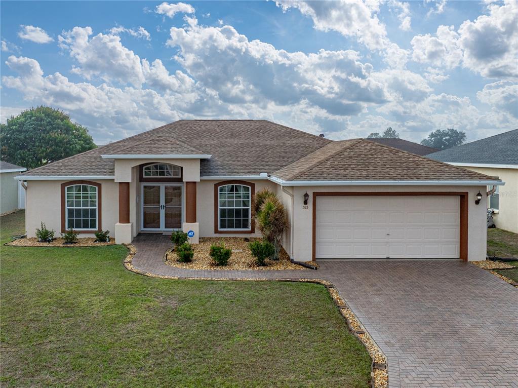 315 Cloverdale Road Winter Haven, FL 33884 - Photo 7 of 65 a front view of a house with a garden and porch