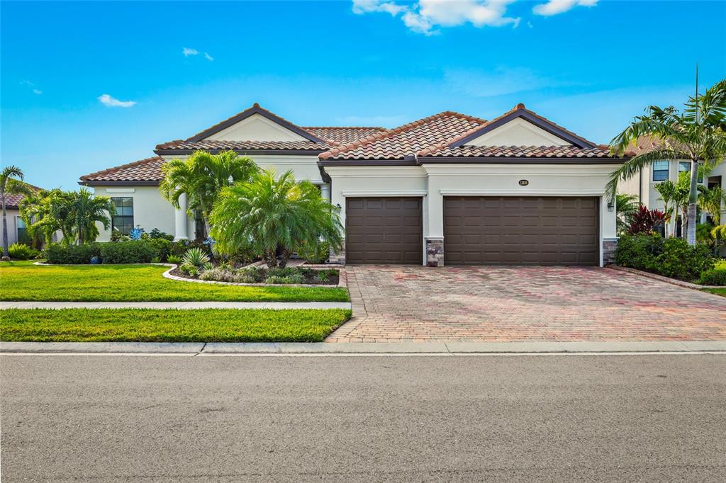 13620 Classico Court Venice, FL 34293 - Photo 1 of 1 a front view of a house with a garden