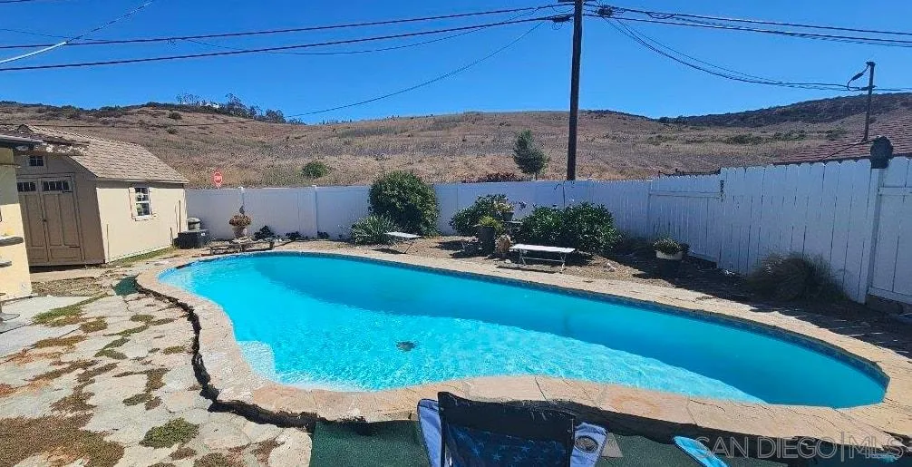 12804 Carriage Road Poway, CA 92064 - Photo 2 of 2 a view of a backyard with a tub and wooden fence
