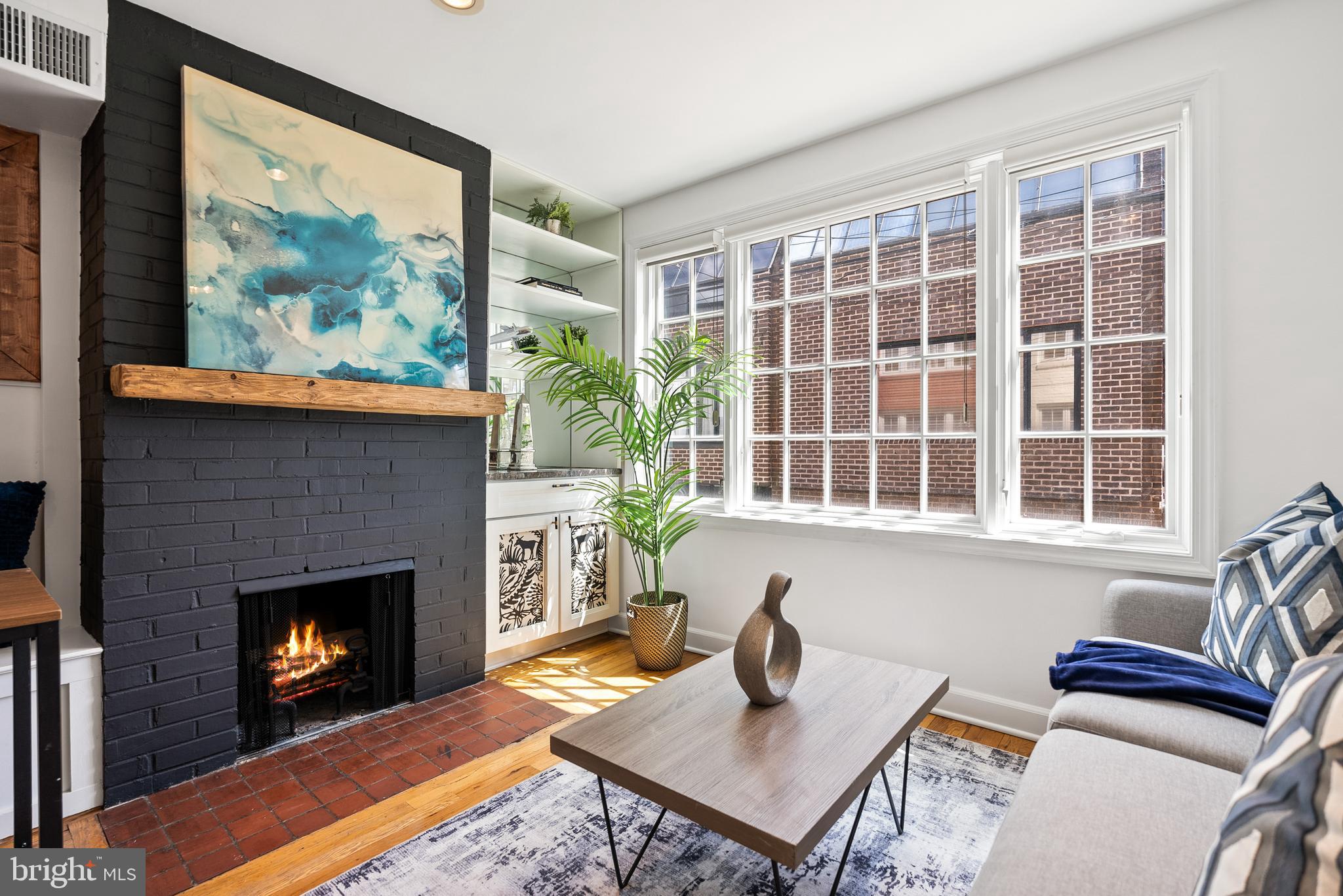 3219 Cherry Hill Lane Washington, DC 20007 - Photo 12 of 32 a living room with furniture a fireplace and windows