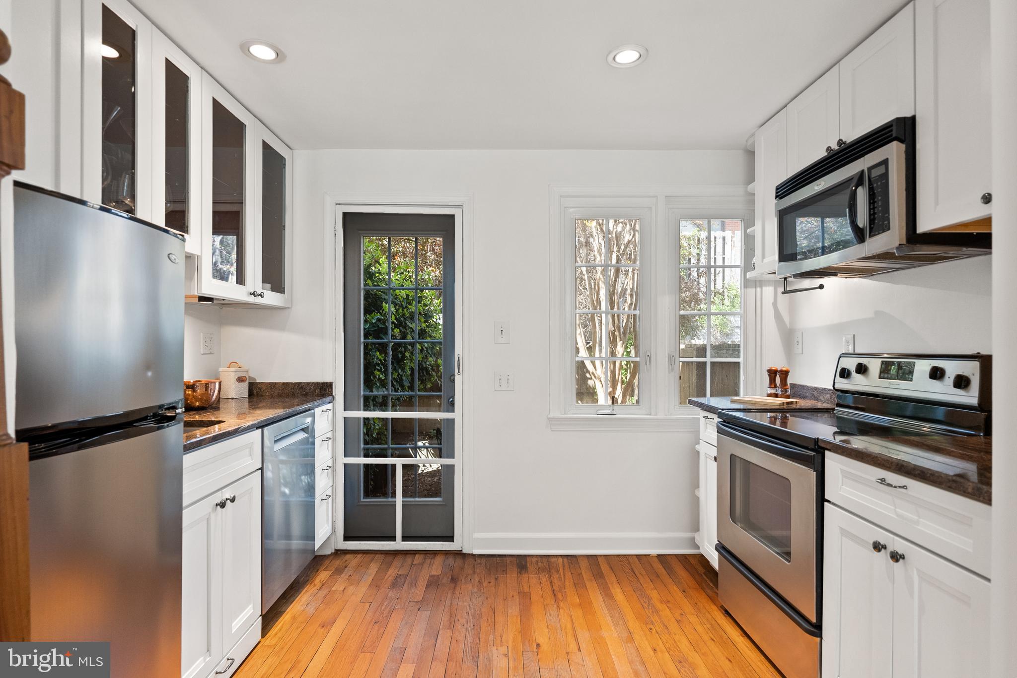 3219 Cherry Hill Lane Washington, DC 20007 - Photo 17 of 32 a kitchen with stainless steel appliances a stove a sink and a refrigerator