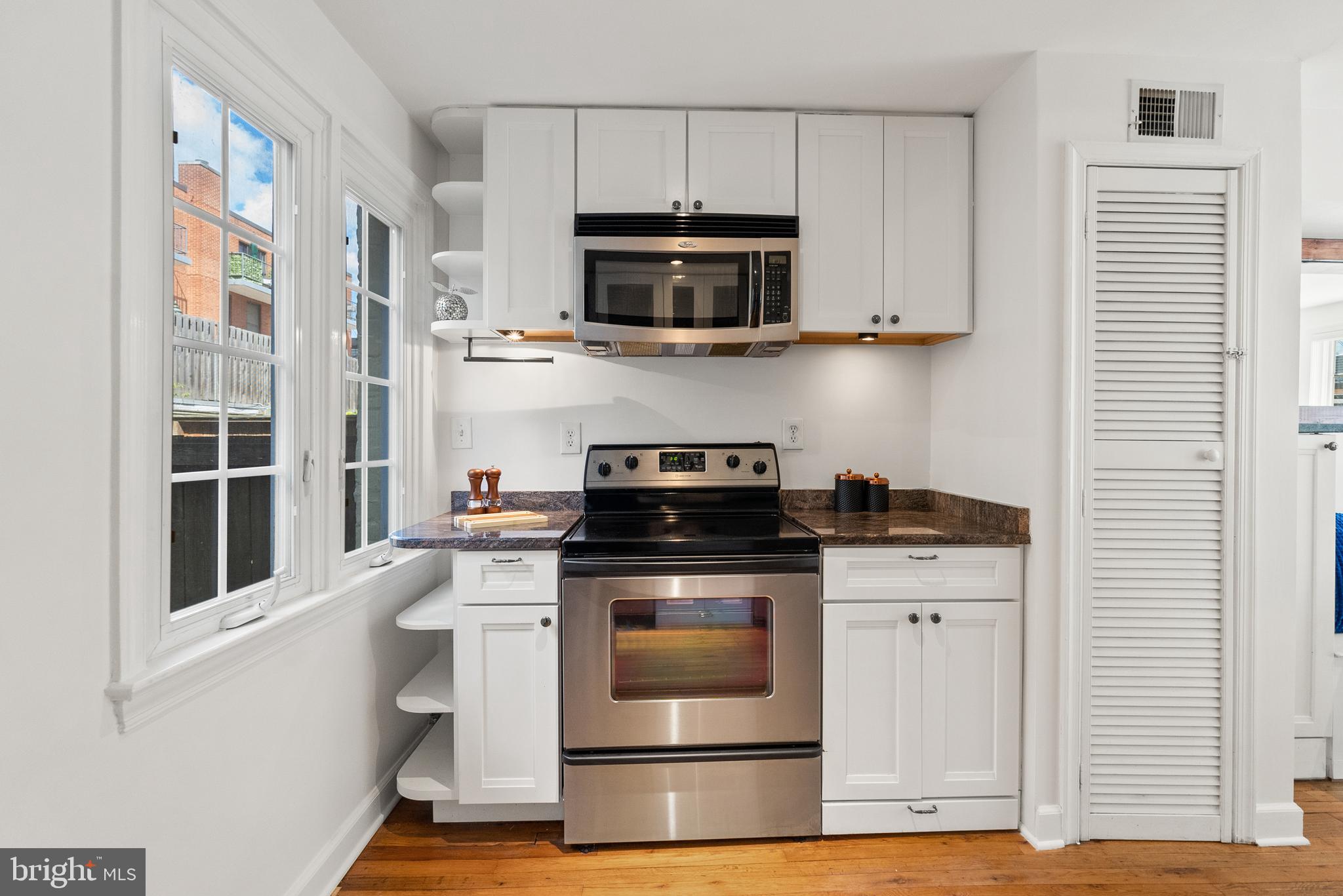 3219 Cherry Hill Lane Washington, DC 20007 - Photo 18 of 32 a kitchen with stainless steel appliances granite countertop a stove a microwave and a refrigerator