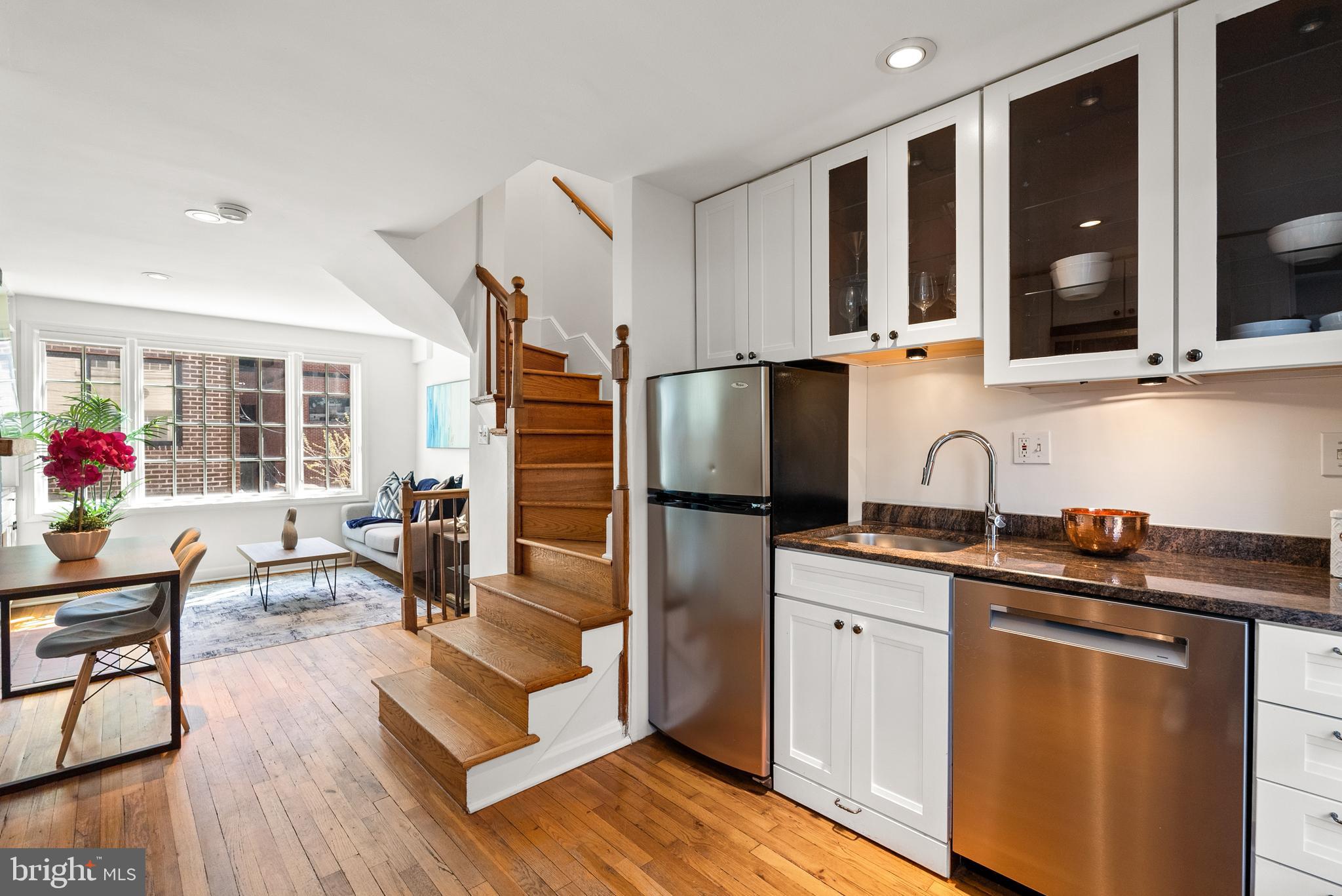 3219 Cherry Hill Lane Washington, DC 20007 - Photo 19 of 32 a kitchen with granite countertop a sink stove and cabinets