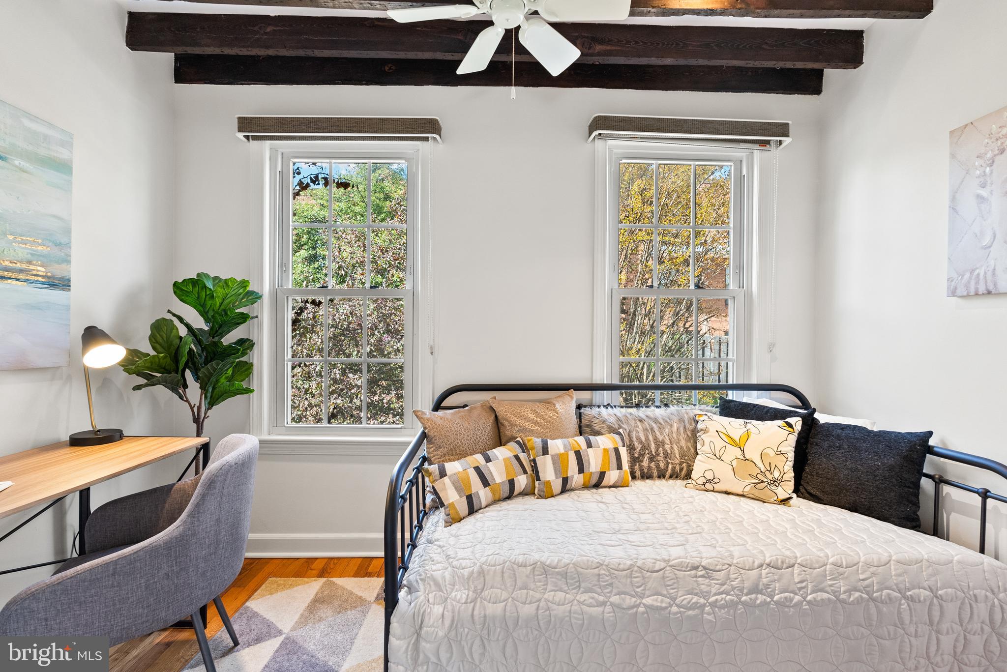 3219 Cherry Hill Lane Washington, DC 20007 - Photo 24 of 32 a bedroom with a bed and a potted plant