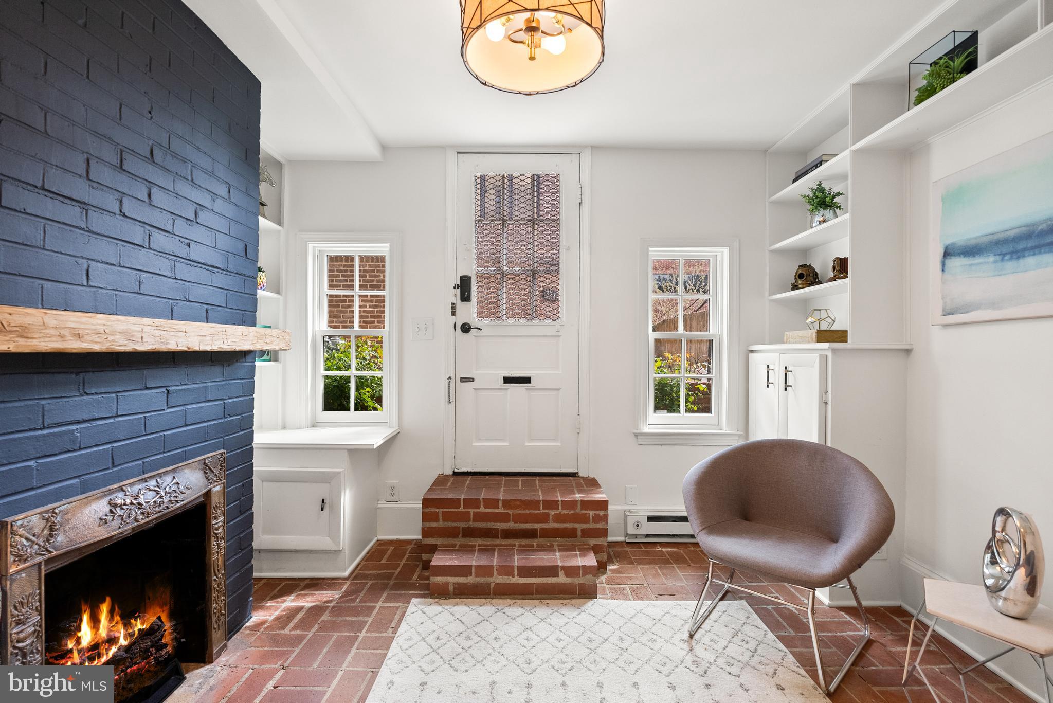 3219 Cherry Hill Lane Washington, DC 20007 - Photo 5 of 32 a living room with furniture a fireplace and a window
