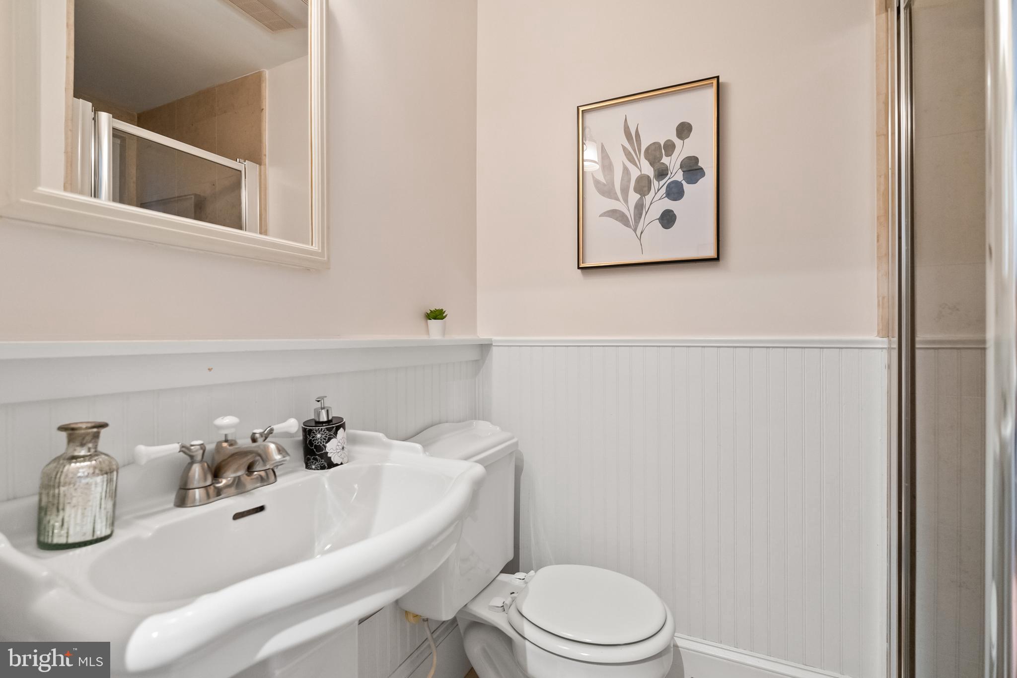 3219 Cherry Hill Lane Washington, DC 20007 - Photo 9 of 32 a bathroom with a sink mirror and toilet