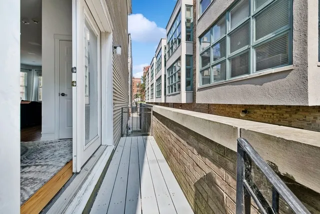 a view of a balcony with wooden floor and staircase