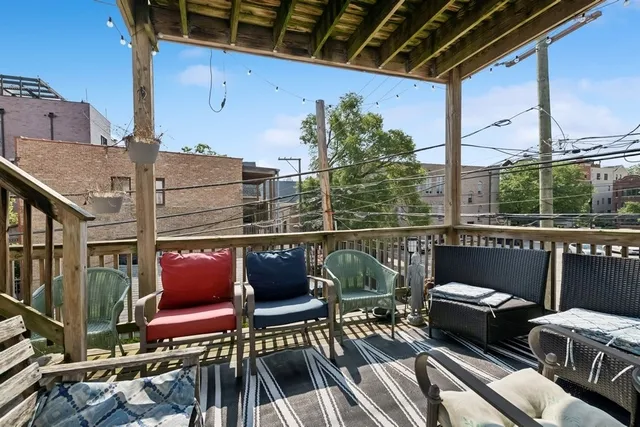a balcony with outdoor seating and plants