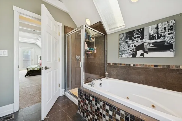 a bathroom with a bathtub and a shower
