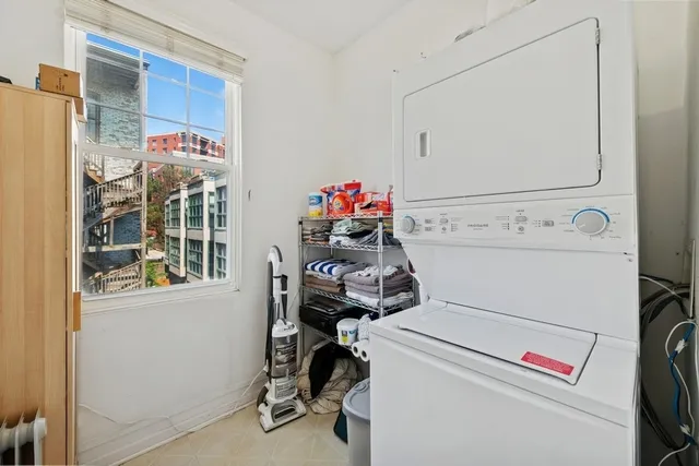 a utility room with dryer washer and a window