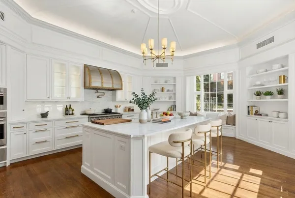 a view of a kitchen sink and wooden floor