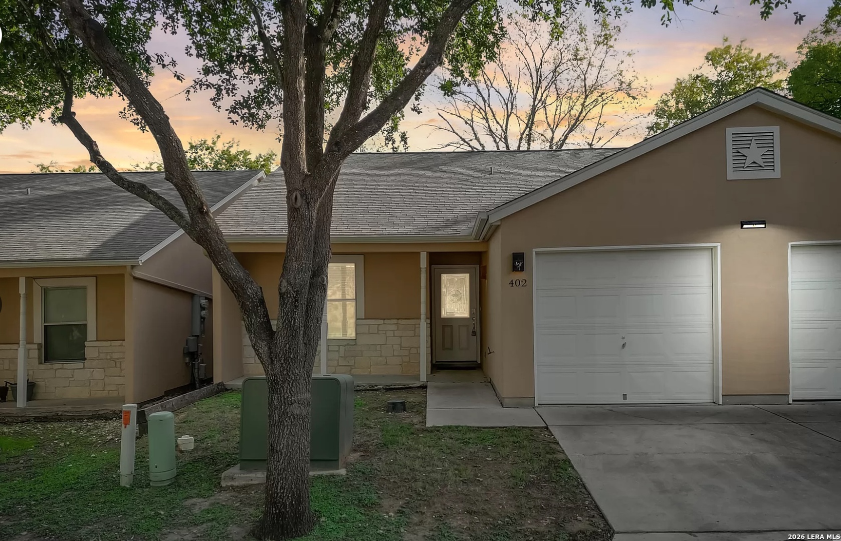 3202 Eisenhauer Road, Unit 402 San Antonio, TX 78209 - Photo 1 of 10 front view of a house with a trees