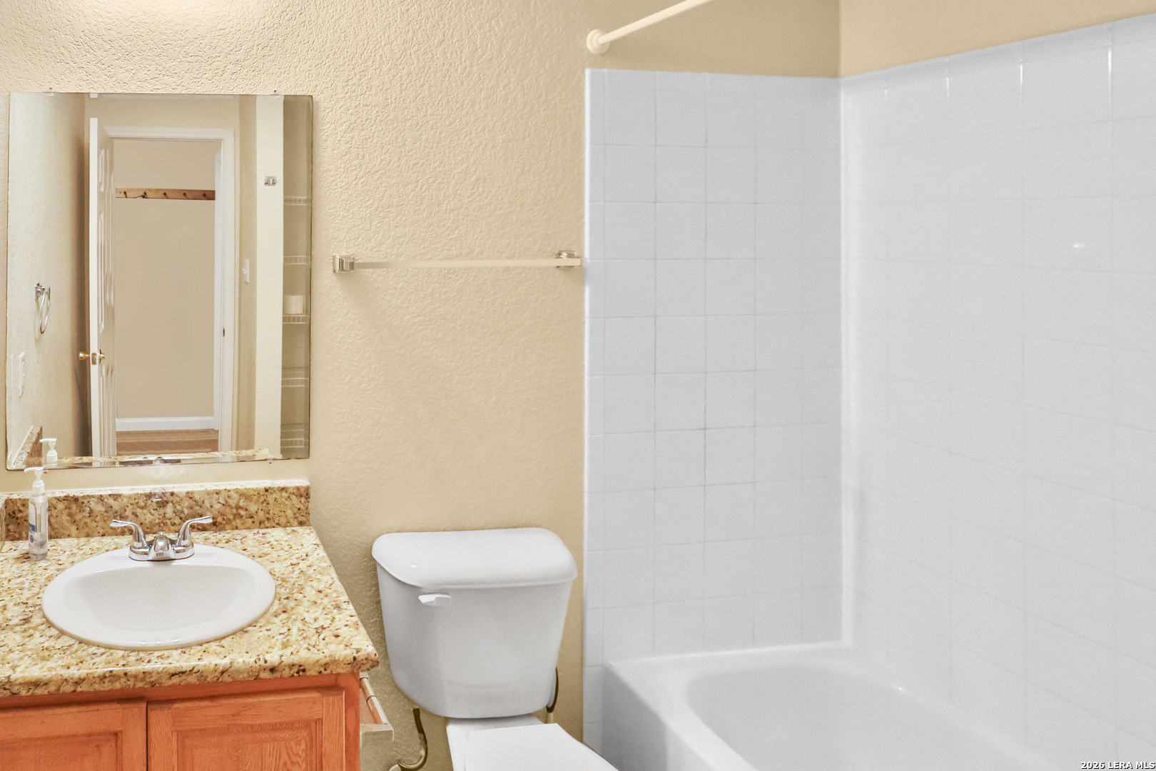 3202 Eisenhauer Road, Unit 402 San Antonio, TX 78209 - Photo 7 of 10 a bathroom with a granite countertop sink toilet and shower