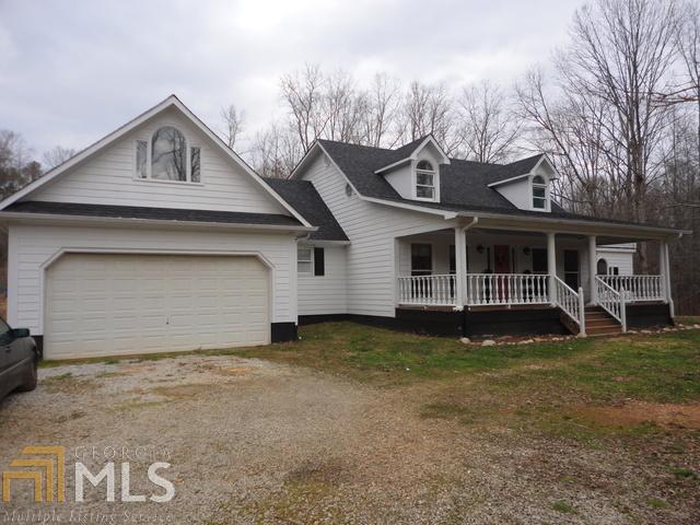 244 Katie Beth Road Comer, GA 30629 - Photo 1 of 1 a front view of a house with a garden and trees