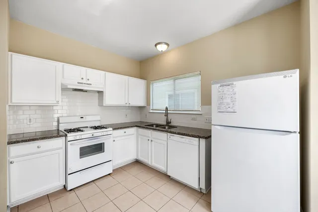 a kitchen with a white cabinets and white appliances