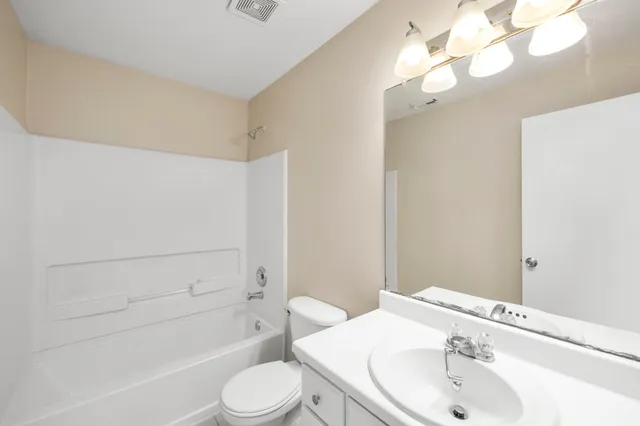 a bathroom with a sink a toilet and bathtub