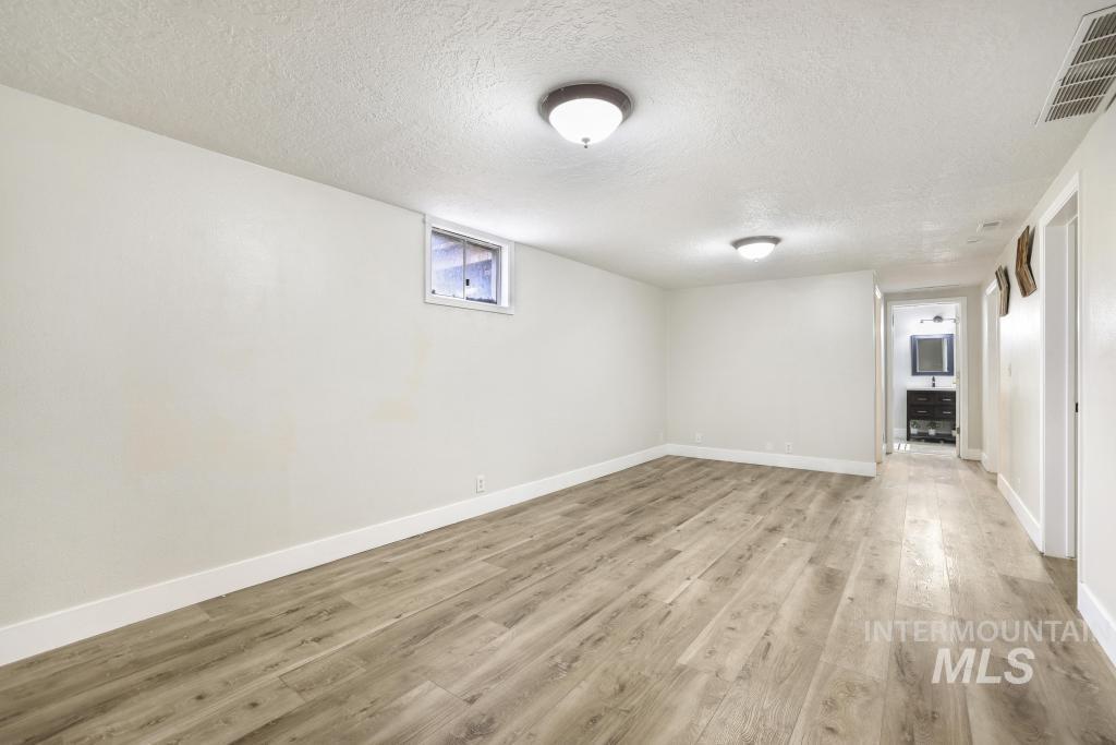 2243 4000 North Filer, ID 83328 - Photo 11 of 30 Below grade area with a textured ceiling and light wood-style flooring