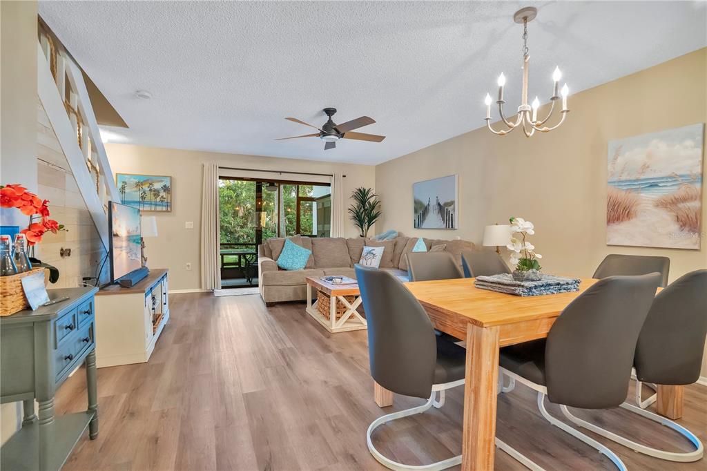 1646 Stickney Point Road, Unit 1646101 Sarasota, FL 34231 - Photo 12 of 67 a view of a dining room with furniture window and wooden floor