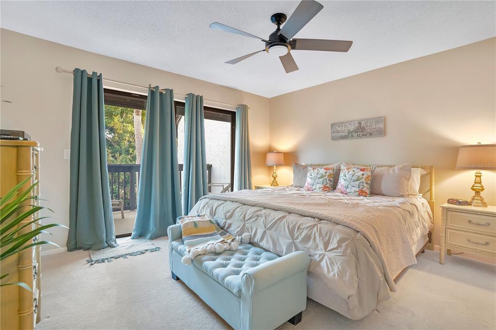 1646 Stickney Point Road, Unit 1646101 Sarasota, FL 34231 - Photo 20 of 67 a spacious bedroom with a bed and a chandelier