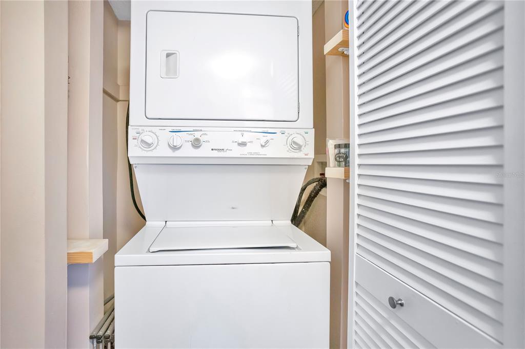 1646 Stickney Point Road, Unit 1646101 Sarasota, FL 34231 - Photo 28 of 67 a utility room with dryer and washer