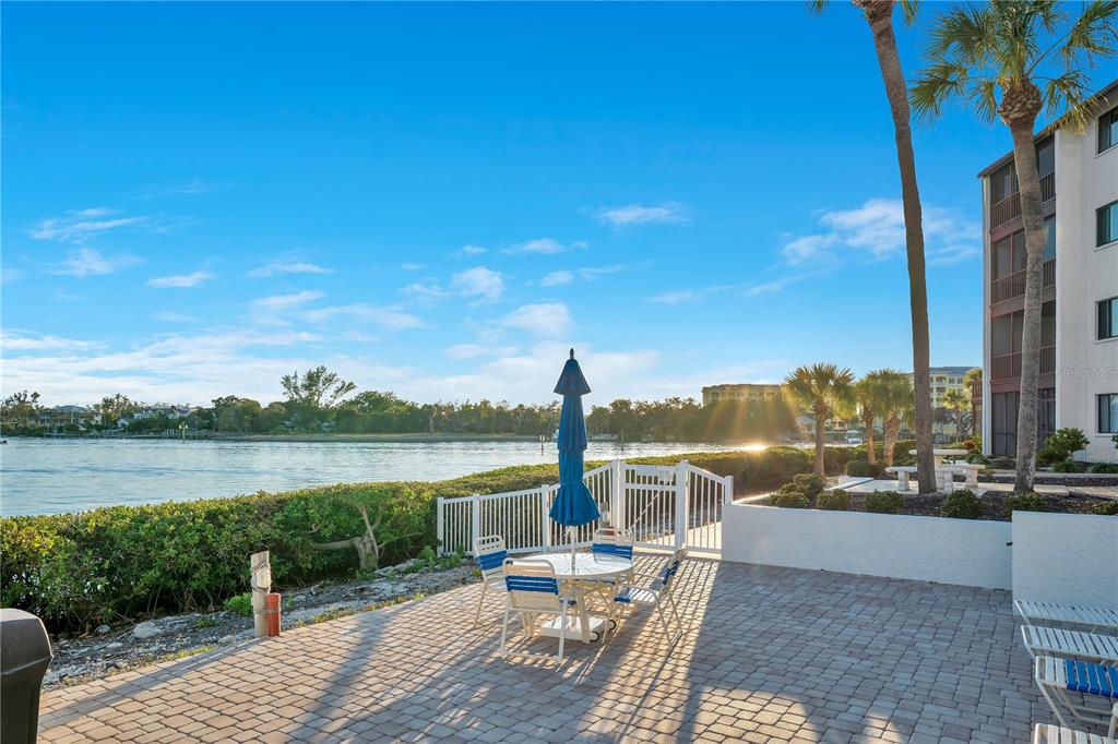 1646 Stickney Point Road, Unit 1646101 Sarasota, FL 34231 - Photo 32 of 67 a view of a lake with couches in the patio