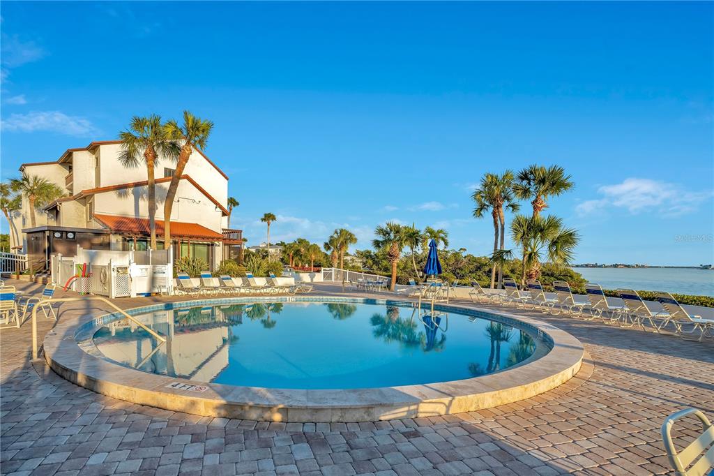 1646 Stickney Point Road, Unit 1646101 Sarasota, FL 34231 - Photo 34 of 67 a view of a swimming pool with outdoor seating