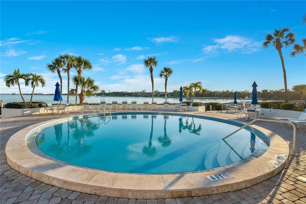 1646 Stickney Point Road, Unit 1646101 Sarasota, FL 34231 - Photo 35 of 67 a view of a swimming pool with a lawn chairs