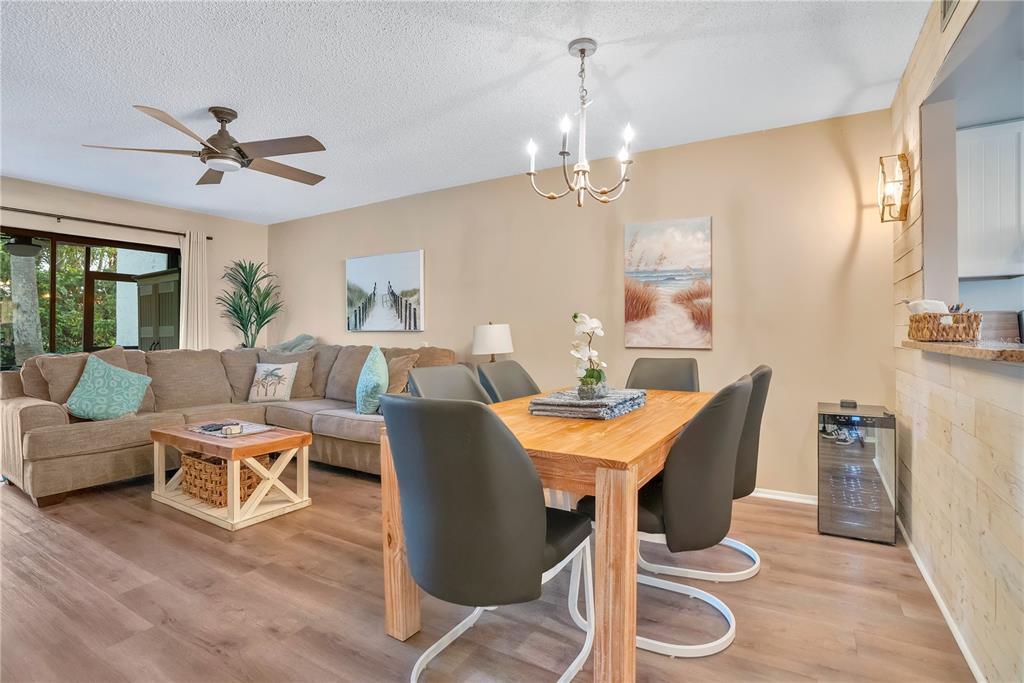 1646 Stickney Point Road, Unit 1646101 Sarasota, FL 34231 - Photo 7 of 67 a living room with furniture a chandelier and a table