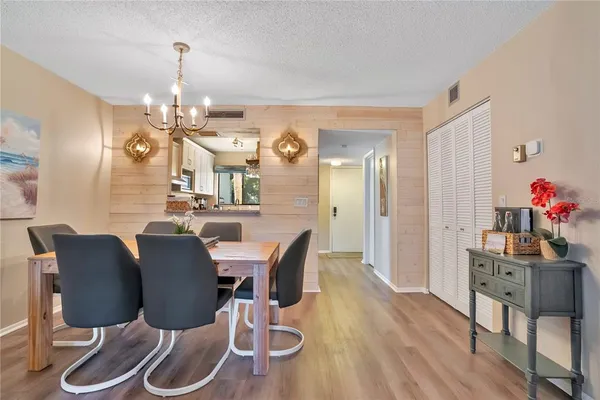 a view of a dining room with furniture wooden floor and a chandelier