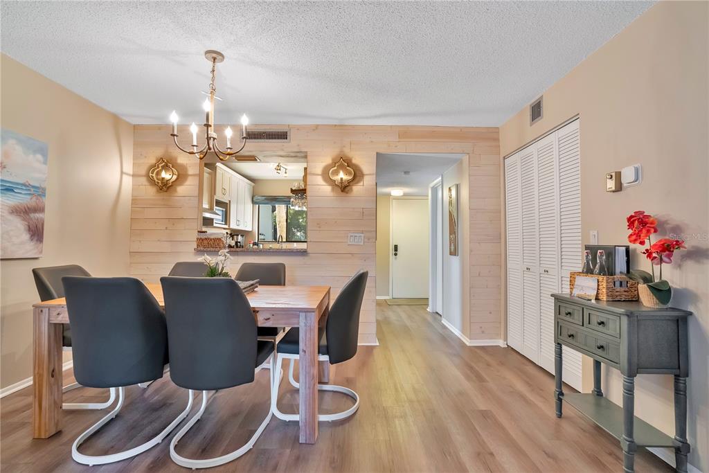 1646 Stickney Point Road, Unit 1646101 Sarasota, FL 34231 - Photo 9 of 67 a view of a dining room with furniture and wooden floor