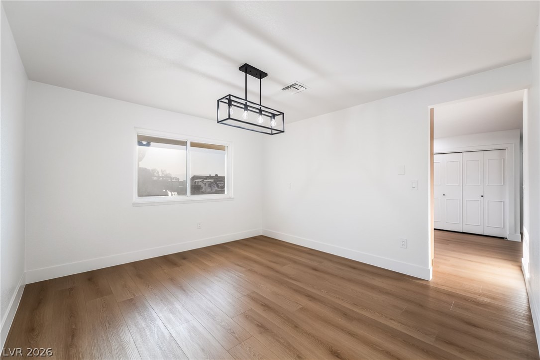 429 Crestway Road Henderson, NV 89015 - Photo 21 of 56 A refined ceiling light fixture illuminates the inviting wood flooring in this versatile space.