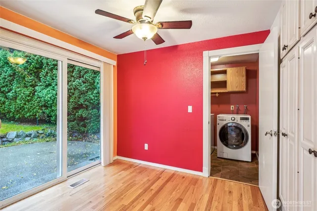 a view of a livingroom with a ceiling fan and a large window
