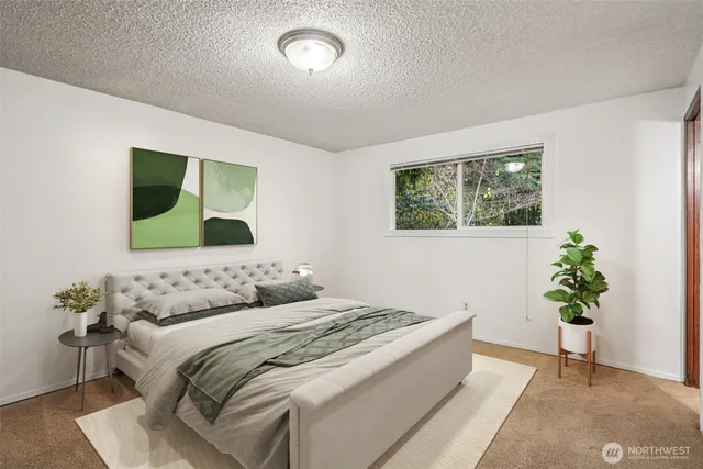 a bedroom with a bed and a potted plant