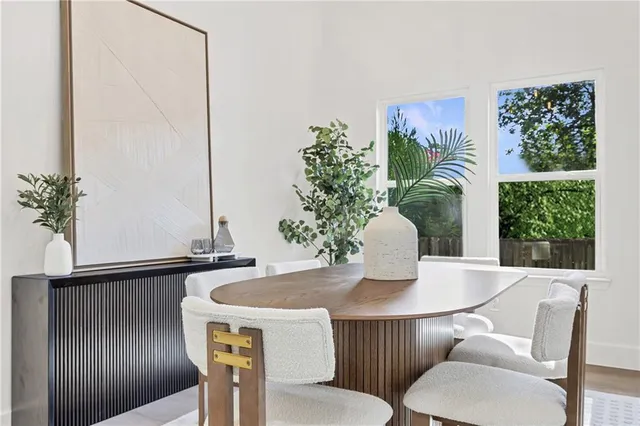 a dining room with furniture and wooden floor