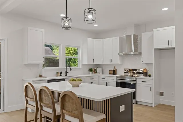 a kitchen with a stove a sink a dining table and chairs