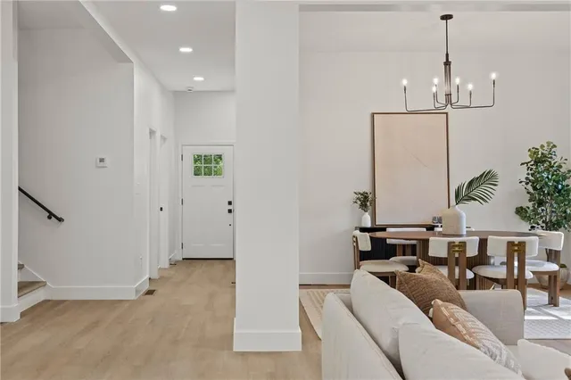 a living room with furniture and a chandelier