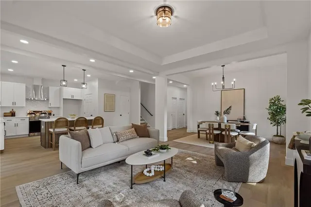 a living room with furniture and a chandelier