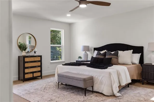 a bedroom with a bed and a chandelier