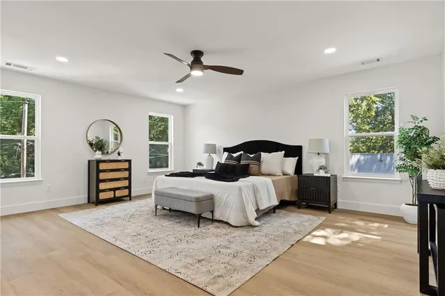a bedroom with a large bed and a window