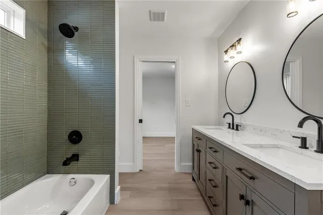 a bathroom with a double vanity sink and a mirror
