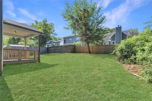 a view of a deck with a floor to ceiling window and wooden floor